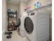 Modern laundry room with front loading washer and dryer and shelving at 376 Mikita Dr., Surfside Beach, SC 29575