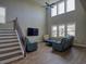 Bright and airy living room boasts soaring ceilings, large windows, hardwood floors, and comfortable seating at 376 Mikita Dr., Surfside Beach, SC 29575