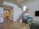 Open-concept living area showcases hardwood floors, a staircase with iron railings, and comfortable seating at 376 Mikita Dr., Surfside Beach, SC 29575
