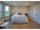 Main bedroom featuring large windows, dark wood floors, and closet access at 376 Mikita Dr., Surfside Beach, SC 29575