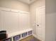 Mudroom with coat hooks, bench and shelving with blue storage baskets at 376 Mikita Dr., Surfside Beach, SC 29575