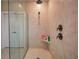 Close up view of a tiled shower with a glass partition and bronze fixtures and showerhead at 376 Mikita Dr., Surfside Beach, SC 29575