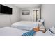 Bedroom with two beds, TV, and sliding closet door. Plenty of space to relax at 403 71St Ave. N # 5, Myrtle Beach, SC 29572