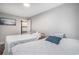 Bright bedroom featuring two twin beds, soft bedding, and a side table with artwork at 403 71St Ave. N # 5, Myrtle Beach, SC 29572
