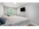 Cozy bedroom with two beds, a flat-screen TV, and a window with natural light at 403 71St Ave. N # 5, Myrtle Beach, SC 29572