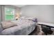 Bright bedroom featuring a comfortable bed, modern desk, and a sunlit window at 403 71St Ave. N # 5, Myrtle Beach, SC 29572