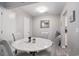 Light-filled dining room with a white marble-top table and stylish chairs and lighting at 403 71St Ave. N # 5, Myrtle Beach, SC 29572