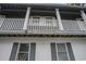 View of 'Myrtle Beach Villas' with a balcony and dark shutters at 403 71St Ave. N # 5, Myrtle Beach, SC 29572