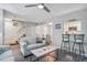 Cozy living room with plush sofas, stairway, and an adjacent dining area and kitchen at 403 71St Ave. N # 5, Myrtle Beach, SC 29572