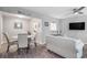 Open-concept living room and dining area with modern decor, hardwood floors and bright light at 403 71St Ave. N # 5, Myrtle Beach, SC 29572