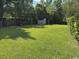 Expansive backyard with lush green lawn and mature trees, providing ample space and privacy at 4041 Long Line Ln., Myrtle Beach, SC 29579