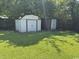 Backyard features two storage sheds on a green lawn beneath the shade of large trees at 4041 Long Line Ln., Myrtle Beach, SC 29579