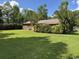 Home exterior shows green lawn, mature shrubbery and partial view of the home at 4041 Long Line Ln., Myrtle Beach, SC 29579