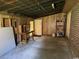 Spacious garage interior features wooden paneling, exposed ceiling beams, and concrete flooring at 4041 Long Line Ln., Myrtle Beach, SC 29579
