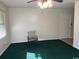 Cozy living room with green carpet, ceiling fan and natural light from window at 4041 Long Line Ln., Myrtle Beach, SC 29579
