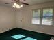 Living room featuring green carpet, ceiling fan, and natural light from the windows at 4041 Long Line Ln., Myrtle Beach, SC 29579