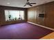 Living room has retro carpeting, stone accent wall and large window at 4041 Long Line Ln., Myrtle Beach, SC 29579