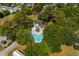 Aerial view of home with a large pool, mature trees, and outdoor entertaining space at 4115 Little River Rd. # 1-E, Myrtle Beach, SC 29577