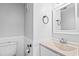 Neat bathroom featuring a granite-look countertop, beadboard paneling, and a bright white painted wall at 4115 Little River Rd. # 1-E, Myrtle Beach, SC 29577