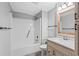Bright bathroom with a white shower and bath combination, plus a traditional vanity and mirror at 4115 Little River Rd. # 1-E, Myrtle Beach, SC 29577