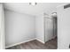 This vacant bedroom offers wood-look flooring, ample closet space, and soft lighting, creating a cozy retreat at 4115 Little River Rd. # 1-E, Myrtle Beach, SC 29577