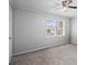 Spacious bedroom featuring neutral carpet, a ceiling fan, and ample natural light at 4115 Little River Rd. # 1-E, Myrtle Beach, SC 29577