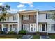 Charming townhome featuring a brick facade, black shutters, and inviting front entrances under a blue and cloudy sky at 4115 Little River Rd. # 1-E, Myrtle Beach, SC 29577