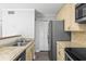 Kitchen showcases stainless steel appliances, updated cabinetry, and convenient access to storage at 4115 Little River Rd. # 1-E, Myrtle Beach, SC 29577