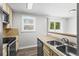 Bright kitchen features stainless appliances, backsplash, eat-in area, and natural light from two windows at 4115 Little River Rd. # 1-E, Myrtle Beach, SC 29577