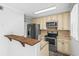 Well-lit kitchen features stainless steel appliances, light wood cabinets, and stone countertops at 4115 Little River Rd. # 1-E, Myrtle Beach, SC 29577