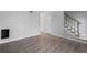 Open-concept living space with wood floors, neutral walls, and nearby stairs, presenting a versatile and inviting atmosphere at 4115 Little River Rd. # 1-E, Myrtle Beach, SC 29577