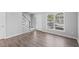 Well-lit living area with wood floors, a staircase, neutral walls, and ample natural light, ideal for a comfortable lifestyle at 4115 Little River Rd. # 1-E, Myrtle Beach, SC 29577