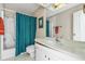 Bathroom featuring a shower with teal curtain, white vanity, and a large mirror at 4701 N Kings Hwy. # 8, Myrtle Beach, SC 29577