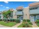 Charming townhouse with brick facade, blue trim, small balconies, and well-maintained landscaping at 4701 N Kings Hwy. # 8, Myrtle Beach, SC 29577