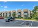 Row of charming townhouses featuring brick facade, blue trim, balconies, parking spaces and landscaping at 4701 N Kings Hwy. # 8, Myrtle Beach, SC 29577