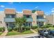 Charming townhouse with brick facade, blue trim, small balconies, and well-maintained landscaping at 4701 N Kings Hwy. # 8, Myrtle Beach, SC 29577