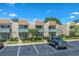 View of townhouses with brick facade, blue trim, balconies, parking spaces and landscaping at 4701 N Kings Hwy. # 8, Myrtle Beach, SC 29577