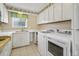 Functional galley kitchen with white cabinets, appliances, and ample countertop space at 4701 N Kings Hwy. # 8, Myrtle Beach, SC 29577