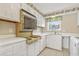 Functional galley kitchen with white cabinets, appliances, and ample countertop space at 4701 N Kings Hwy. # 8, Myrtle Beach, SC 29577
