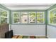 Sunroom featuring multiple windows and a view of the surrounding greenery and nearby buildings at 4701 N Kings Hwy. # 8, Myrtle Beach, SC 29577