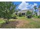 Serene backyard with lush greenery, mature trees, and a glimpse of the house's back exterior at 4726 Southern Trail, Myrtle Beach, SC 29579
