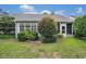 Landscaped backyard featuring a well-maintained lawn, vibrant bushes, and a cozy sunroom at 4726 Southern Trail, Myrtle Beach, SC 29579