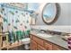 Comfortable bathroom with a decorative shower curtain, a large mirror, and updated fixtures at 4726 Southern Trail, Myrtle Beach, SC 29579