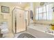 Bright bathroom featuring a glass-enclosed shower, a soaking tub, and updated fixtures at 4726 Southern Trail, Myrtle Beach, SC 29579