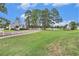 Picturesque community clubhouse with well-manicured landscaping, a pond, and scenic walking path at 4726 Southern Trail, Myrtle Beach, SC 29579