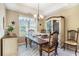Traditional dining room with a tray ceiling, chandelier, and a large china cabinet at 4726 Southern Trail, Myrtle Beach, SC 29579