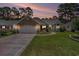 Charming single-story home with manicured lawn, brick accents, and attached two-car garage at 4726 Southern Trail, Myrtle Beach, SC 29579
