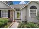 Close up of the home's entry, featuring a decorative glass front door and lush landscaping at 4726 Southern Trail, Myrtle Beach, SC 29579