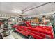 Well-organized garage featuring a red vintage car, ample storage, and workspace for hobbies or projects at 4726 Southern Trail, Myrtle Beach, SC 29579