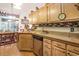 Well-appointed kitchen with light wood cabinetry, stainless steel dishwasher, and dining area at 4726 Southern Trail, Myrtle Beach, SC 29579